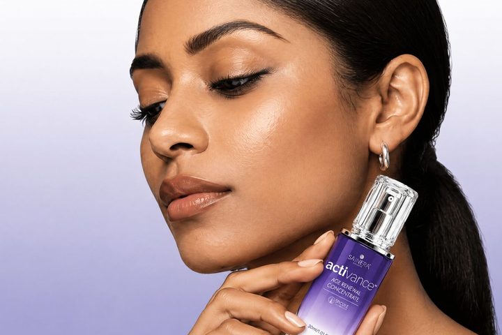 Woman with smooth, radiant skin holding Activance Age Renewal Concentrate